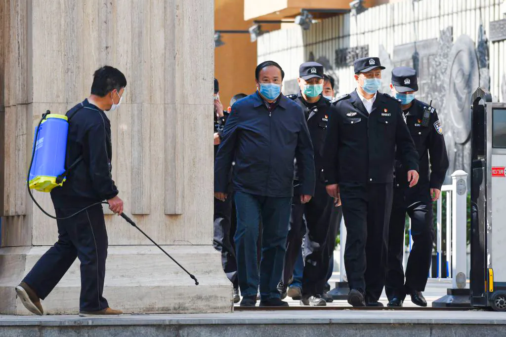 Police and officials emerge from a high school in Beijing on April 27, 2020. (Greg Baker/AFP via Getty Images)