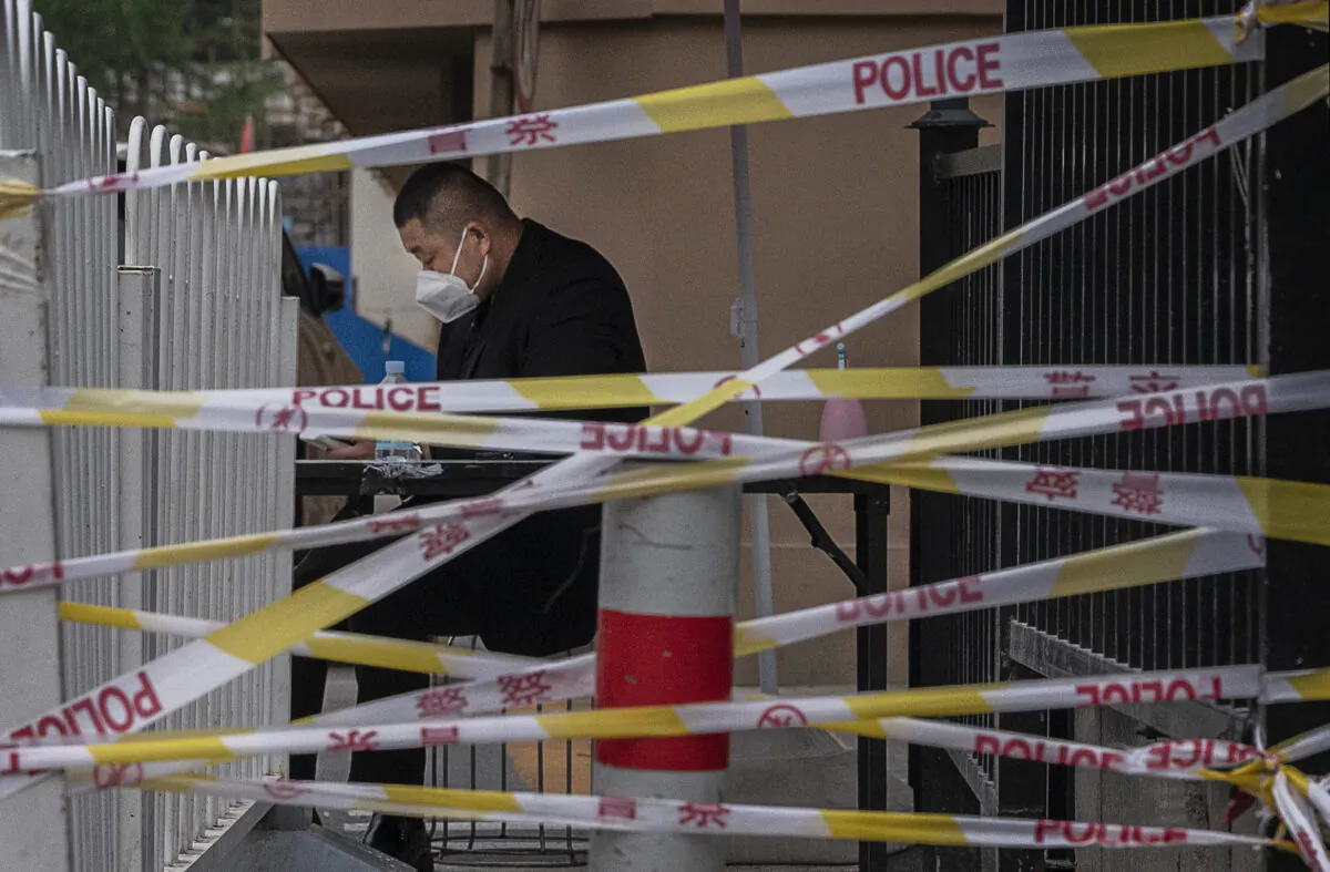 A security guard is seen behind police tape near the Heaven Supermarket and other nightclubs that are at the center of the city's latest COVID-19 outbreak in Beijing. China's capital is working to control a fresh COVID-19 cluster after dozens of people linked to a local nightclub tested positive for the virus. June 13, 2022. (Kevin Frayer/Getty Images)