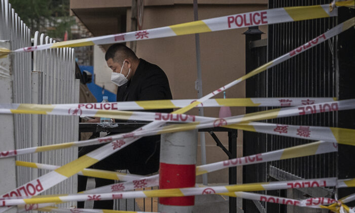 A security guard is seen behind police tape near the Heaven Supermarket and other nightclubs that are at the center of the city's latest COVID-19 outbreak in Beijing. China's capital is working to control a fresh COVID-19 cluster after dozens of people linked to a local nightclub tested positive for the virus.  June 13, 2022. (Kevin Frayer/Getty Images)