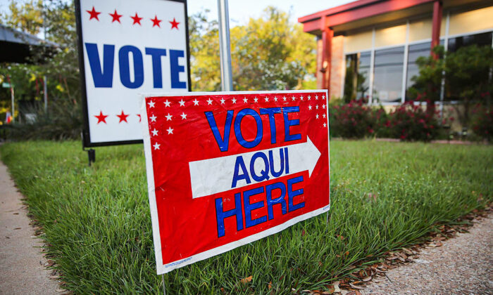 AUSTIN, Texas - APRIL 28:  A bilingual sign stands outside a polling center at public library ahead of local elections on April 28, 2013 in Austin, Texas. Early voting was due to begin Monday ahead of May 11 statewide county elections. The Democratic and Republican parties are vying for the Latino vote nationwide following President Obama's landslide victory among Hispanic voters in the 2012 election.  (Photo by John Moore/Getty Images)