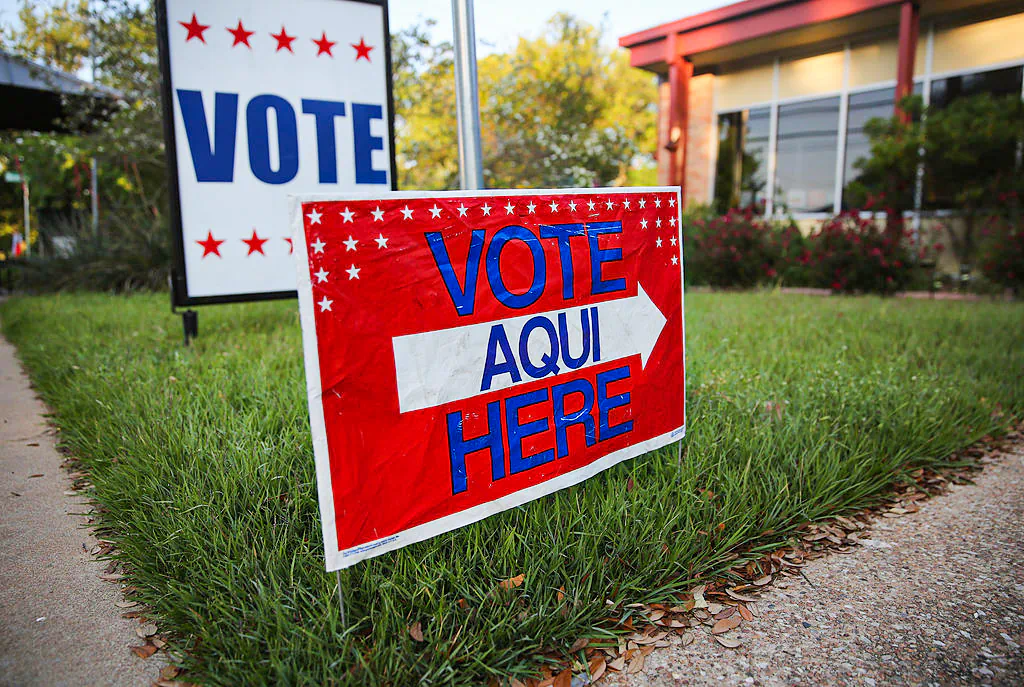 A bilingual sign stands outside a polling center at public library ahead of local elections on April 28, 2013, in Austin, Texas. Early voting was due to begin ahead of May 11 statewide county elections. The Democratic and Republican parties were vying for the Latino vote nationwide following President Obama's landslide victory among Hispanic voters in the 2012 election.  (Photo by John Moore/Getty Images)
