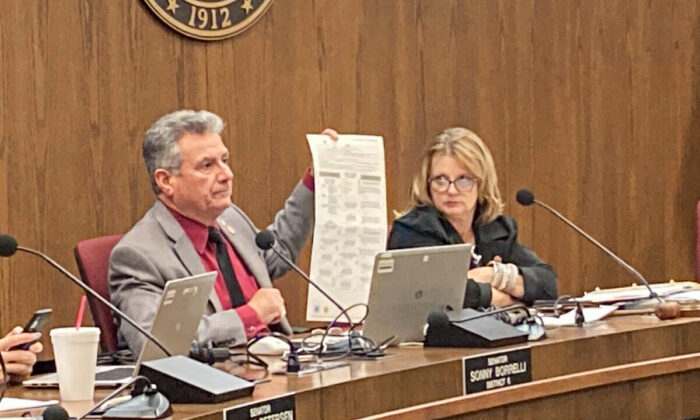 Arizona state Sen. Sonny Borrelli, a Republican, holds up a sample of the current ballot at a hearing of the Arizona Committee on Government in Phoenix on Jan. 24, 2022. Borrelli is the lead sponsor of legislation to establish currency-grade ballot security measures. (Allan Stein/The Epoch Times)