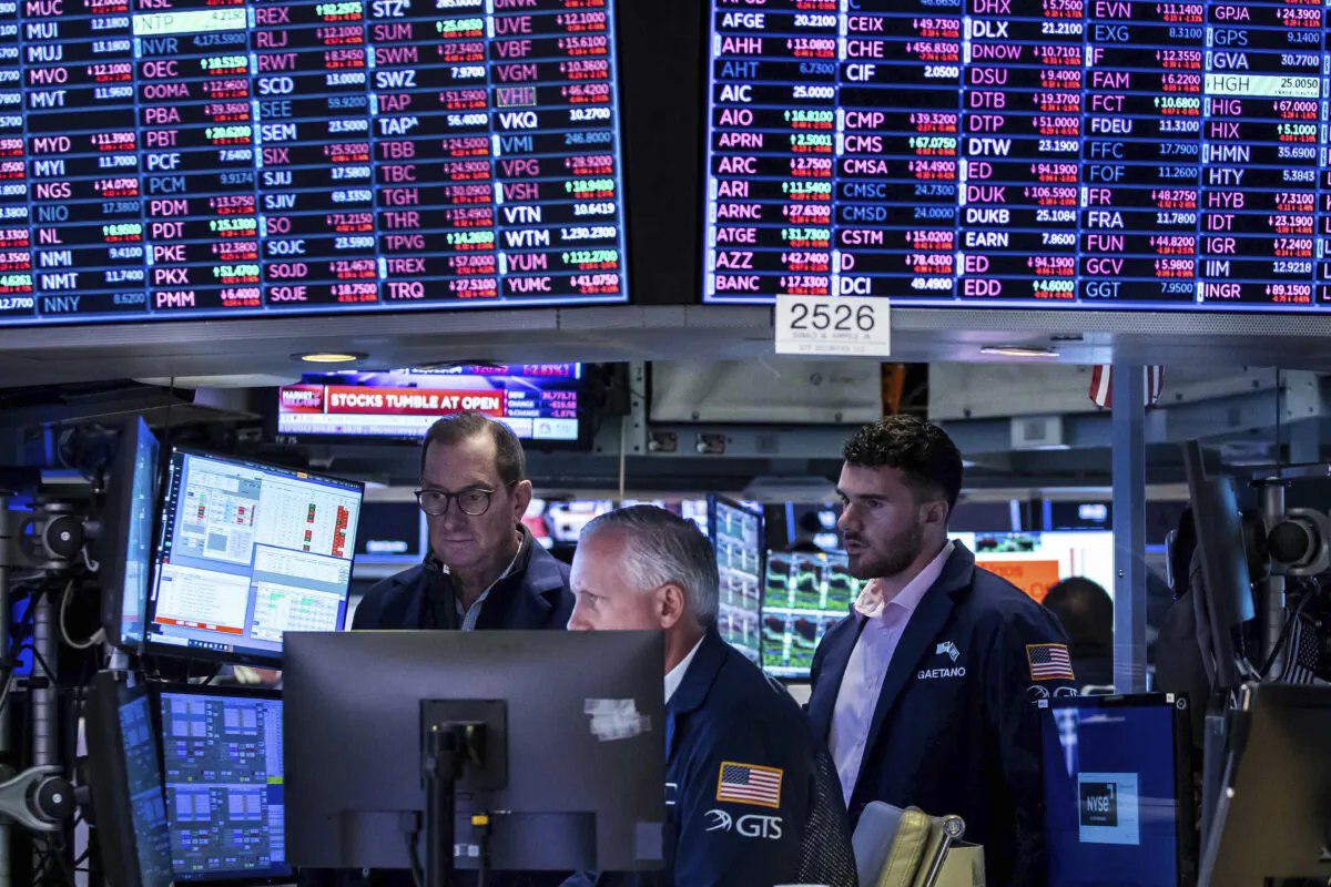 A trio of specialists work at a post on the New York Stock Exchange's floor in New York on June 13, 2022. (Courtney Crow/New York Stock Exchange via AP)