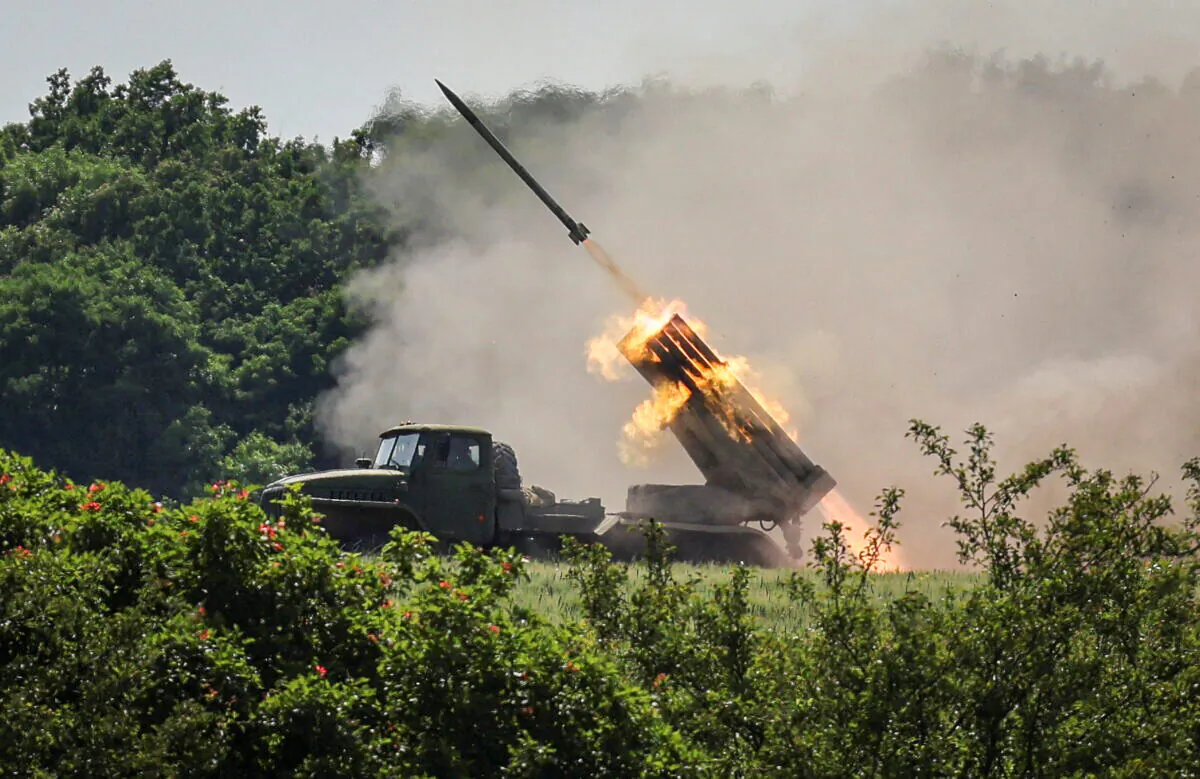 Ukrainian service members fire a BM-21 Grad multiple rocket launch system, near the town of Lysychansk, Luhansk region, Ukraine, on June 12, 2022. (Gleb Garanich/Reuters)