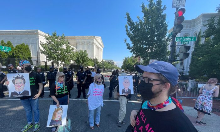 Protesters gather outside the Supreme Court in Washington on June 13, 2022. (Jackson Elliott/The Epoch Times)