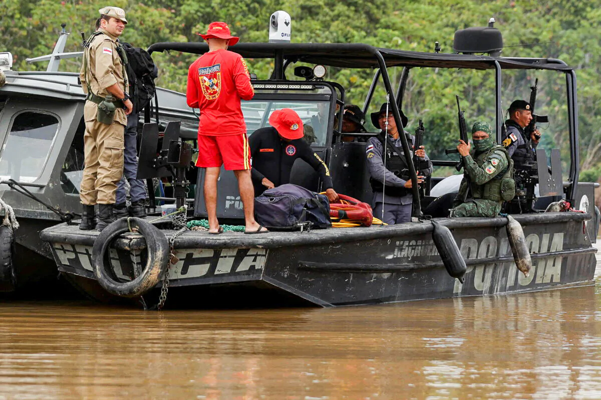 Police officers and rescue team members stand on a boat during the search operation for British journalist Dom Phillips and indigenous expert Bruno Pereira, who went missing while reporting in a remote and lawless part of the Amazon rainforest, near the border with Peru, in Atalaia do Norte, Amazonas state, Brazil, on June 12, 2022. (Bruno Kelly/Reuters)