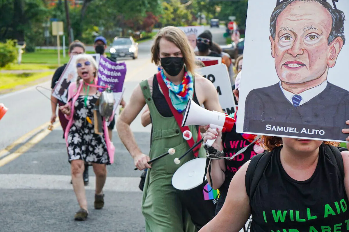 Pro-abortion protesters march to Supreme Court Justice Samuel Alito's neighborhood in Fairfax, Va., on June 13, 2022. (Jackson Elliott/The Epoch Times)  