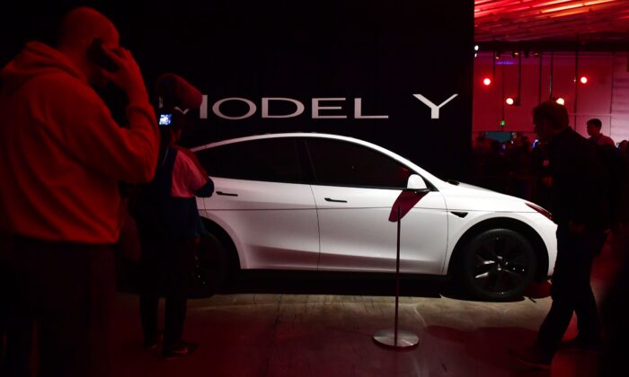 People view a model of the new Tesla Model Y unveiled earlier in Hawthorne, California on March 14, 2019.  (Frederic J. Brown/
AFP via Getty Images)