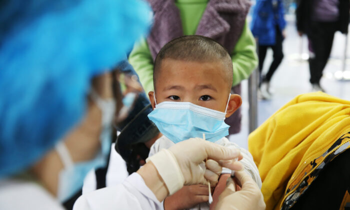 A medical worker vaccinates a child at a temporary vaccination site for COVID-19 in Chongqing, China, on Nov. 3, 2021. (Yang Min/Costfoto/Future Publishing via Getty Images)