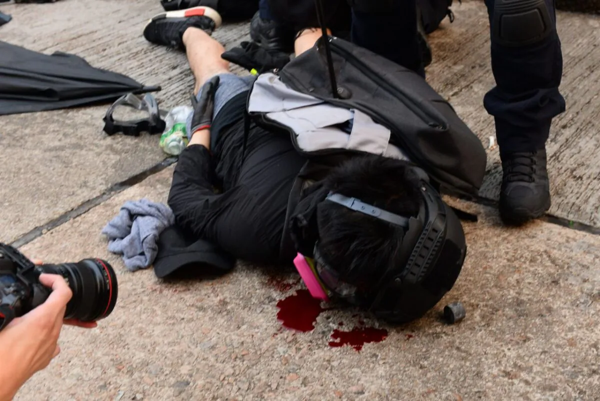A Hong Kong protester after being subdued by members of the Special Tactical Contingent on September 29, 2019. (Song Beelong/The Epoch Times)