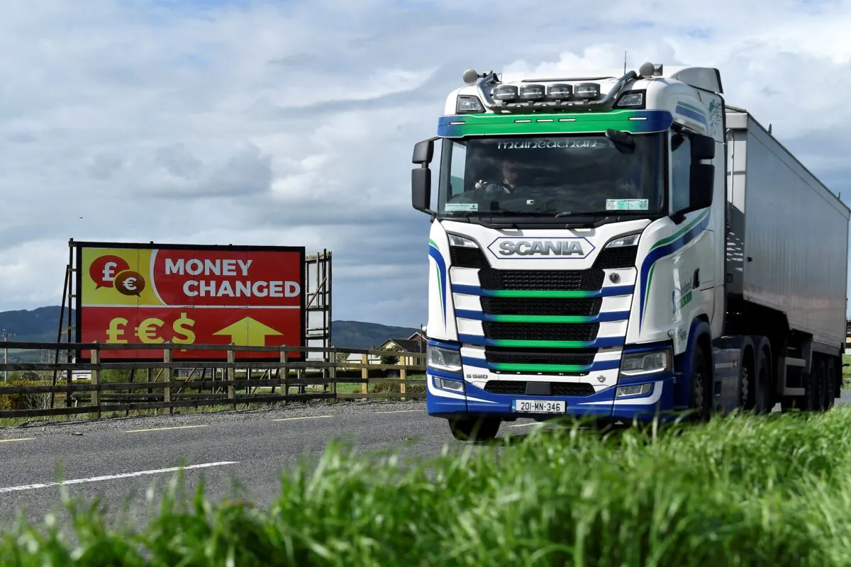 A truck drives past a “money changed” sign for euro, sterling, and dollar currencies on the border between Northern Ireland and the Republic of Ireland, in Jonesborough, Northern Ireland, on May 19, 2022. (Clodagh Kilcoyne /Reuters)