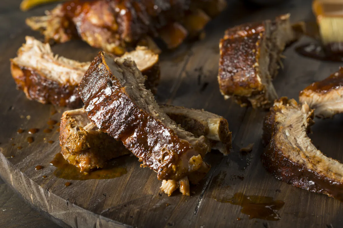 Marinating the ribs and then baking them enclosed in aluminum foil, essentially steaming them, results in a moist, tender slab of meat. (Dreamstime/TNS)