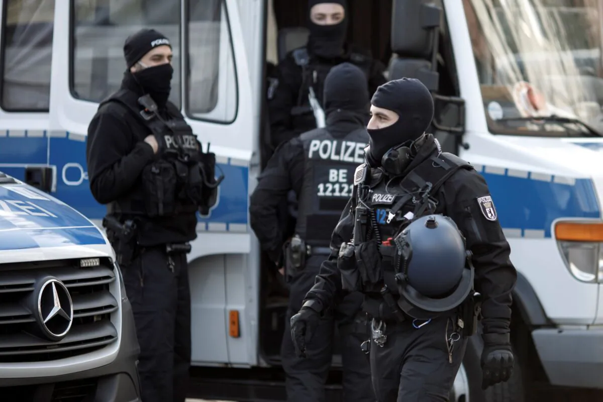 Masked police stand in Maerkisches Viertel district during raids against a suspected ISIS network in Berlin, Germany, on Feb. 25, 2021. (Carsten Koall/Getty Images)