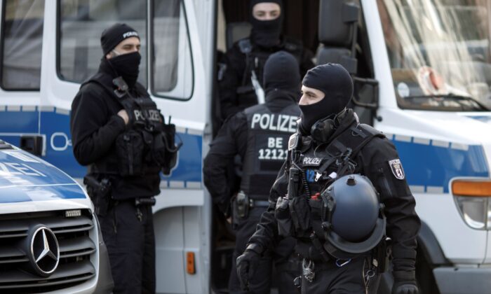 Masked police stand in Maerkisches Viertel district during raids against a suspected ISIS network in Berlin, Germany, on Feb. 25, 2021. (Carsten Koall/Getty Images)