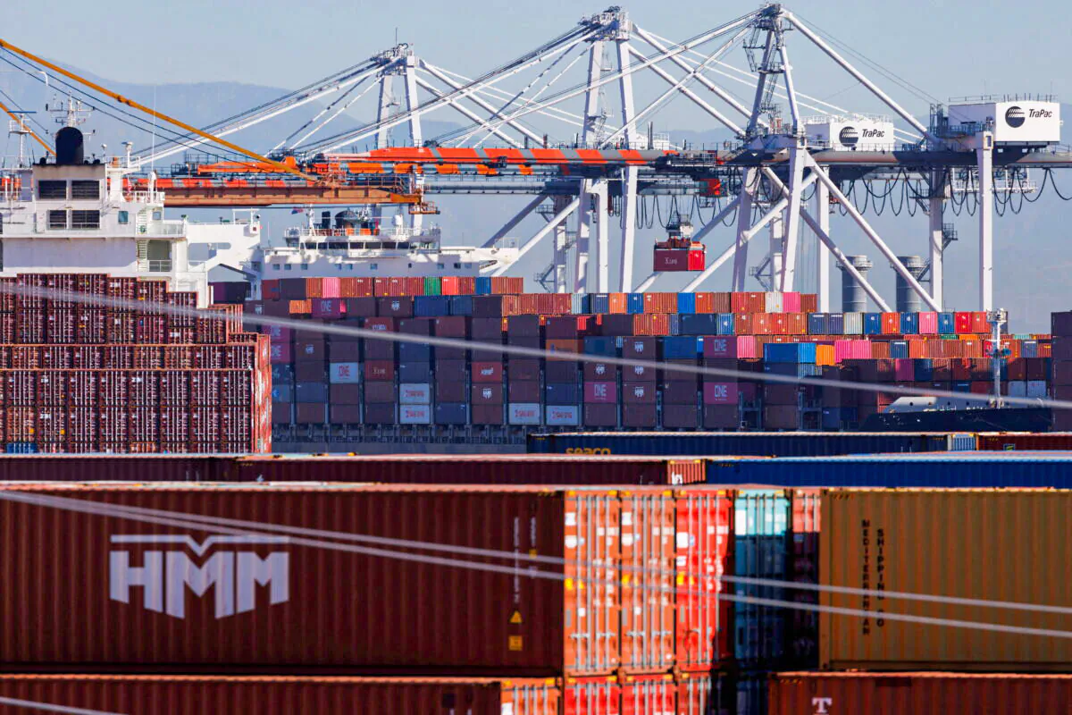 Stacked containers as ships unload their cargo at the Port of Los Angeles on Nov. 22, 2021. (Mike Blake/Reuters)
