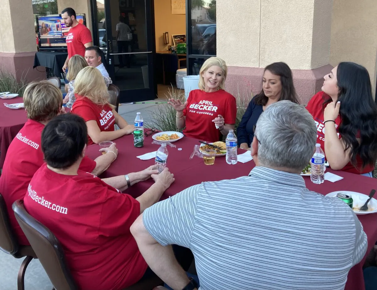 April Becker, center, relaxes with volunteers outside her campaign office in Summerlin shortly before she was declared the winner of the Nevada Republican Congressional District 3 primary. (John Haughey/The Epoch Times)
