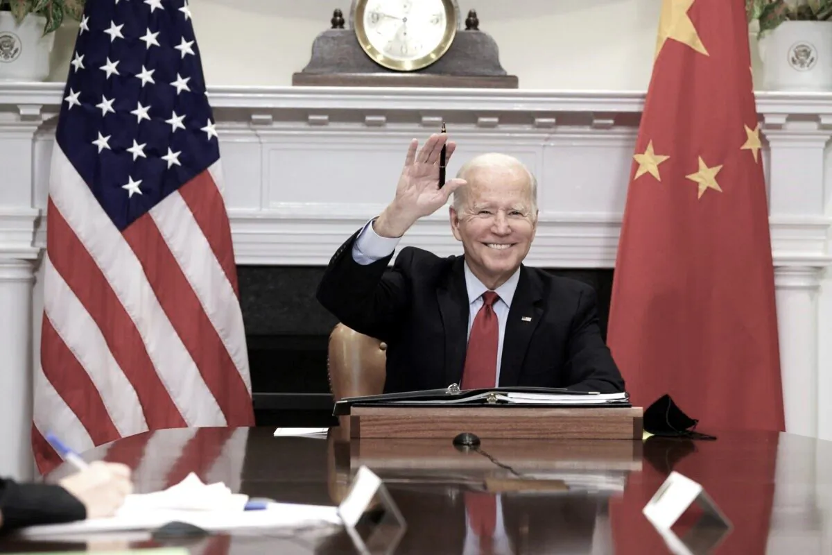 President Joe Biden waves as he participates in a virtual meeting with Chinese leader Xi Jinping at the Roosevelt Room of the White House in Washington on Nov. 15, 2021. (Alex Wong/Getty Images)