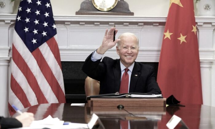 President Joe Biden waves as he participates in a virtual meeting with Chinese leader Xi Jinping at the Roosevelt Room of the White House in Washington on Nov. 15, 2021. (Alex Wong/Getty Images)