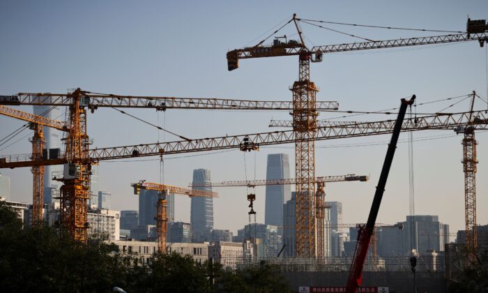 A view shows cranes in front of the skyline of the Central Business District in Beijing on Oct. 18, 2021. (Thomas Peter/Reuters)