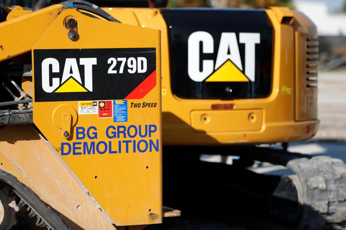 Caterpillar 279D Compact Track Loader (L) and 308E2 CR Mini Hydraulic Excavator (R) at a demolition site in Fort Lauderdale, Fla., on May 8, 2019. (Wilfredo Lee/AP Photo)