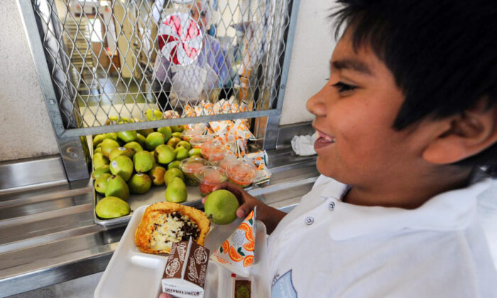 A cafeteria worker supervises lunches for school children at the Normandie Avenue Elementary School in South Central Los Angeles on Dec. 2, 2010. (Mark Ralston/AFP/Getty Images)