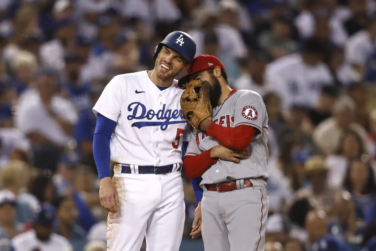 Freddie Freeman #5 of the Los Angeles Dodgers shares a moment with Anthony Rendon #6 of the Los Angeles Angels on third base during the fourth inning at Dodger Stadium in Los Angeles, on June 14, 2022. (Michael Owens/Getty Images)