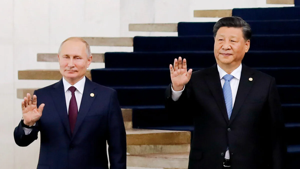 Russian President Vladimir Putin (L) and Chinese leader Xi Jinping pose for a photo during the 11th BRICS Summit in Brasilia, Brazil, on Nov. 14, 2019. (Sergio Lima/AFP via Getty Images)
