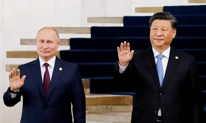 Russian President Vladimir Putin (L) and Chinese leader Xi Jinping pose for a photo during the 11th BRICS Summit in Brasilia, Brazil, on Nov. 14, 2019. (Sergio Lima/AFP via Getty Images)