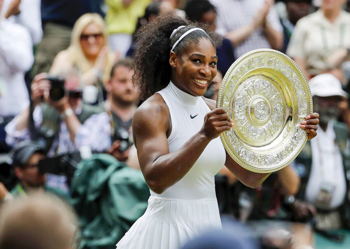 Serena Williams of the United States holds her trophy after winning the women's singles final against Angelique Kerber of Germany on day thirteen of the Wimbledon Tennis Championships in London on July 9, 2016. (Ben Curtis/AP Photo)