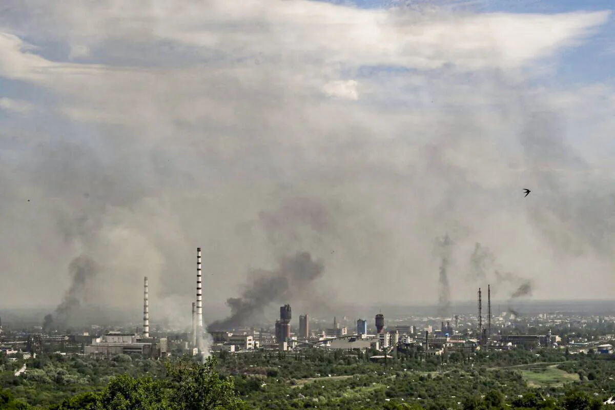 Smoke and dirt rise from the city of Severodonetsk during fighting between Ukrainian and Russian troops at the eastern Ukrainian region of Donbas on June 14, 2022. (Aris Messinis/AFP via Getty Images)