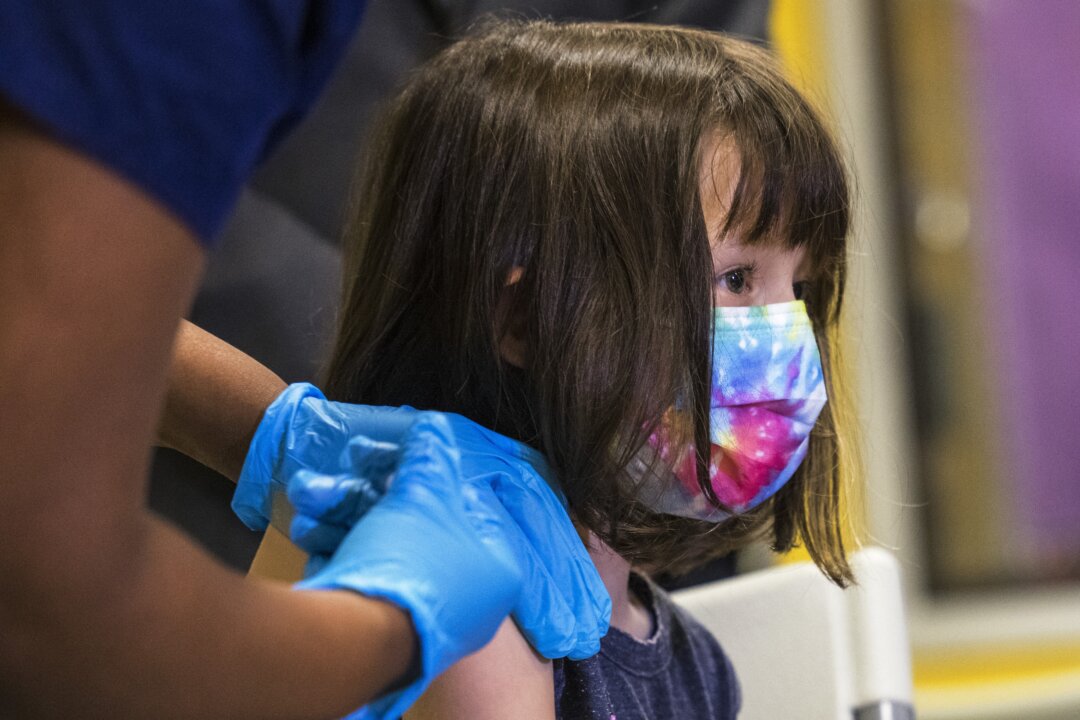 A 5-year-old girl gets a Pfizer COVID-19 vaccine on Nov. 8, 2021. (Michael M. Santiago/Getty Images)