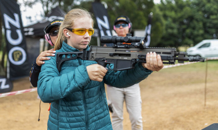 A young woman shoots with a CZ 805 BREN rifle during a gun show event for women with more than 140 participants in Bronkhorstspruit, South Africa on April 2, 2022. (Guillem Sartorio/AFP via Getty Images)