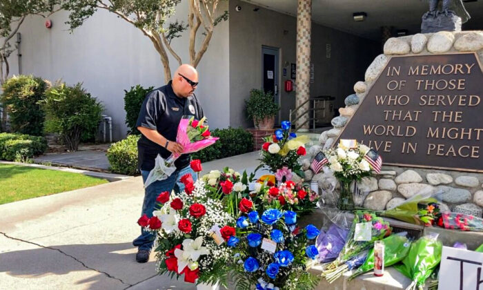 Local officials and community members mourn the two El Monte officers killed in the line of duty at a June 14 motel shooting in front of the El Monte Police Department on June 15, 2022. (Annie Wang/NTD Television)