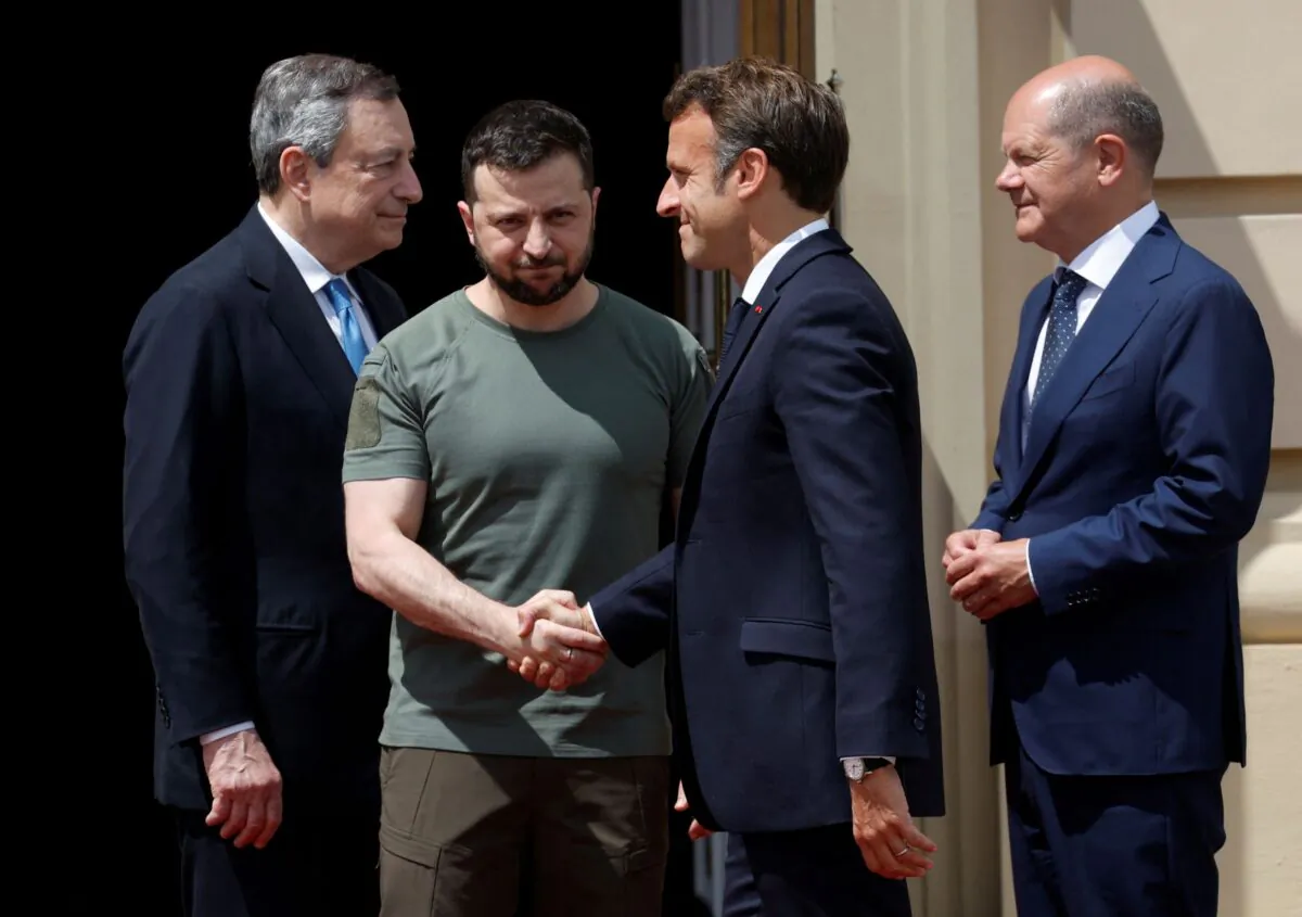 Ukrainian President Volodymyr Zelenskyy greets French President Emmanuel Macron as German Chancellor Olaf Scholz and Italian Prime Minister Mario Draghi stand outside the Mariyinsky Palace in Kyiv, Ukraine, on June 16, 2022. (Valentyn Ogirenko??/Reuters)