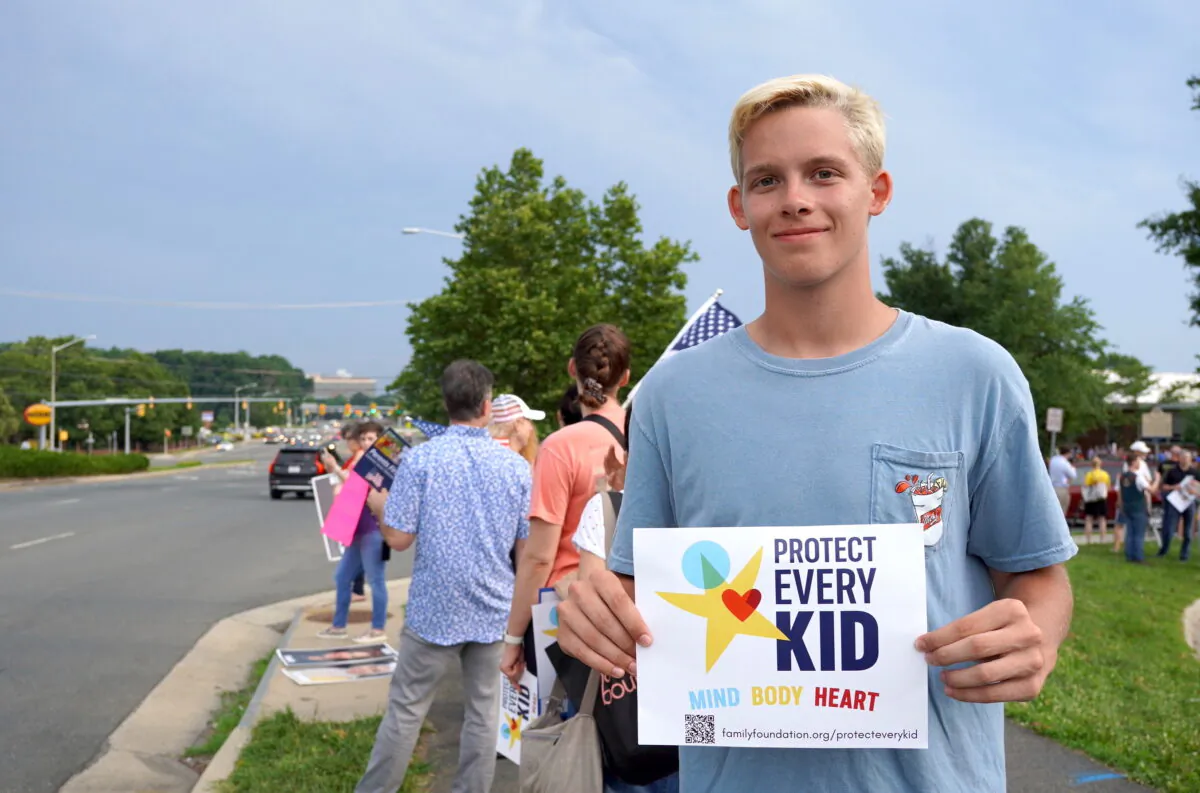 A student who graduated from a Fairfax County high school in 2022, takes part in a protest in Falls Church, Va., on June 16, 2022. (Terri Wu/The Epoch Times)