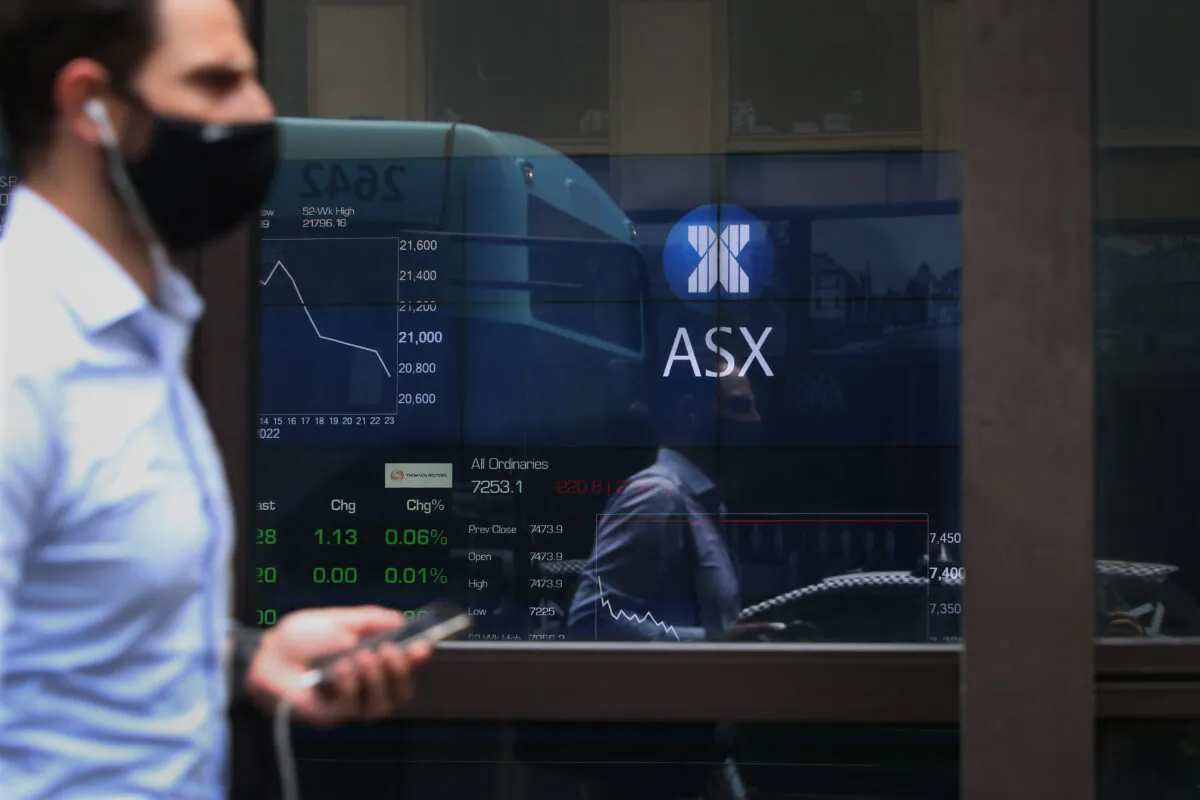 A pedestrian is reflected in the window of the Australian Securities Exchange in Sydney, Australia, on Feb. 25, 2022. (Lisa Maree Williams/Getty Images)