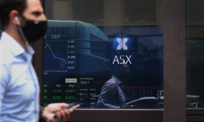 A pedestrian is reflected in the window of the Australian Securities Exchange in Sydney, Australia, on Feb. 25, 2022. (Lisa Maree Williams/Getty Images)