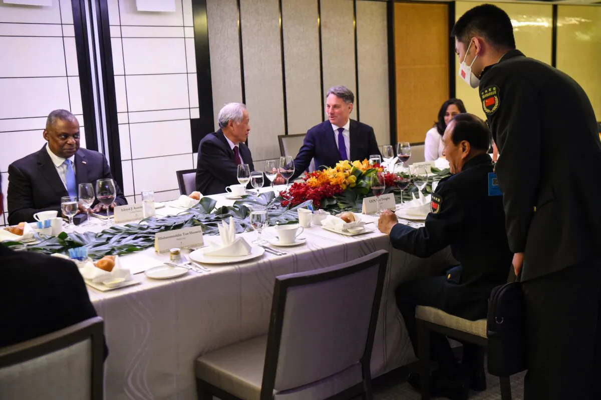Chinese Defence Minister Wei Fenghe (R) talks to U.S. Defense Secretary Lloyd Austin (L) during the ministerial roundtable luncheon at the Shangri-La Dialogue summit in Singapore on June 11, 2022. (Roslan Rahman/AFP via Getty Images)