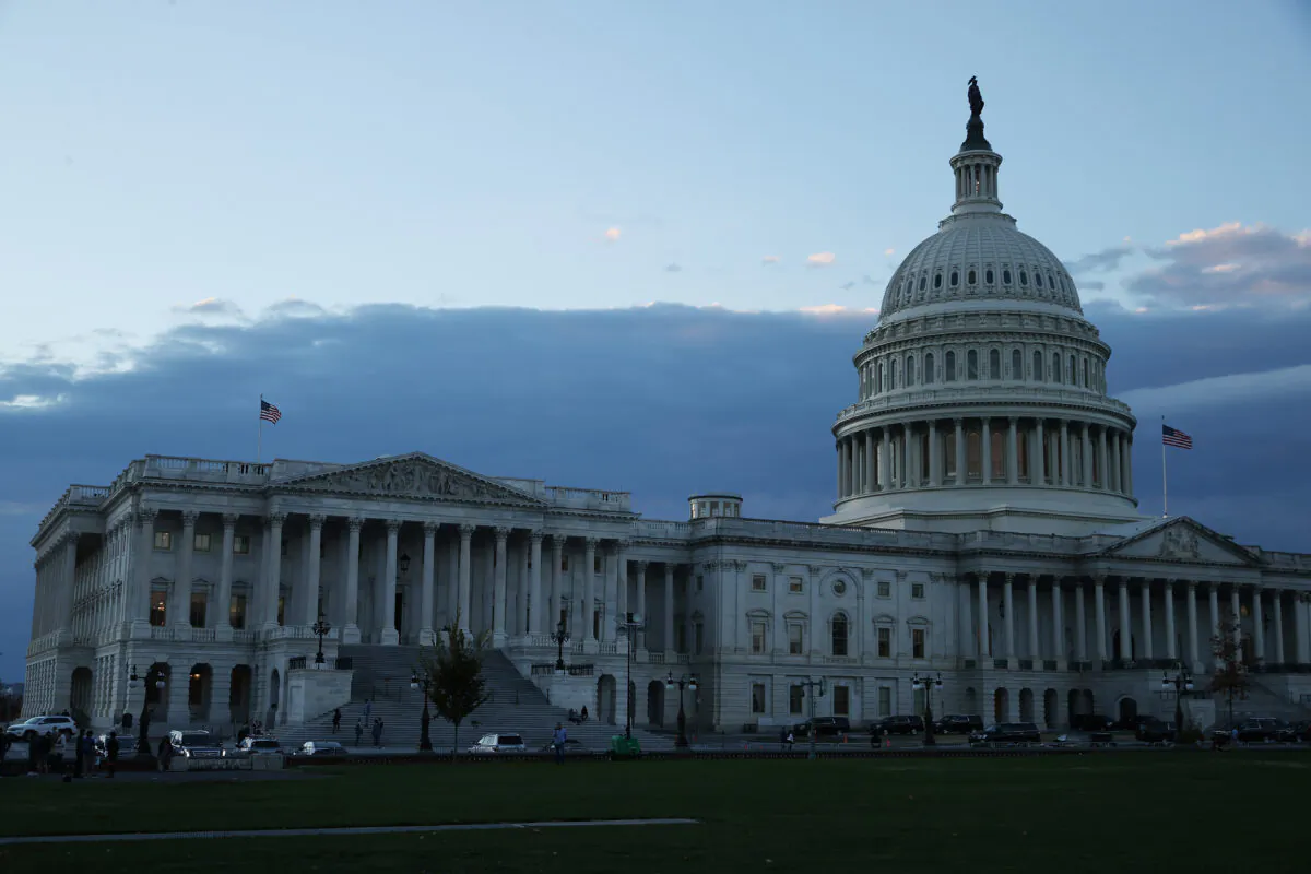The sun sets behind the U.S. Capitol in Washington on Nov. 18, 2021. Following the final Congressional Budget Office cost estimate, House Democrats are hoping to vote on President Joe Biden's $1.75 trillion social benefits and climate legislation on Nov. 18. (Chip Somodevilla/Getty Images)
