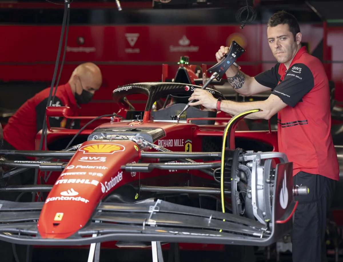 Ferrari mechanics work on the car of Carlos Sainz at the Canadian Grand Prix, June 16, 2022, in Montreal. (The Canadian Press/Ryan Remiorz)
