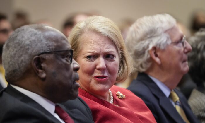 Ginni Thomas, center, speaks to Supreme Court Justice Clarence Thomas during an event in Washington on Oct. 21, 2021. (Drew Angerer/Getty Images)