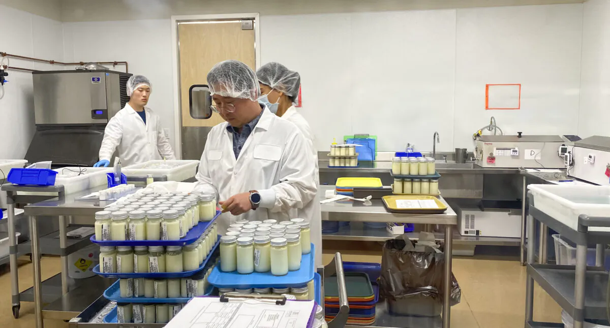 Workers prepare bottled milk in the pasteurization room at Mothers’ Milk Bank in San Jose, Calif., on June 8, 2022. (Ilene Eng/NTD Television)