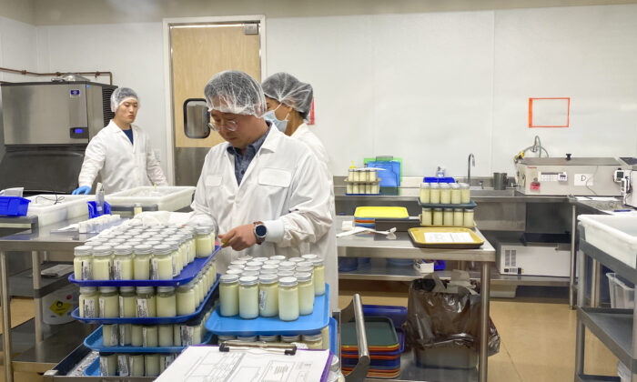 Workers prepare bottled milk in the pasteurization room at Mothers’ Milk Bank in San Jose, Calif., on June 8, 2022. (Ilene Eng/NTD Television)