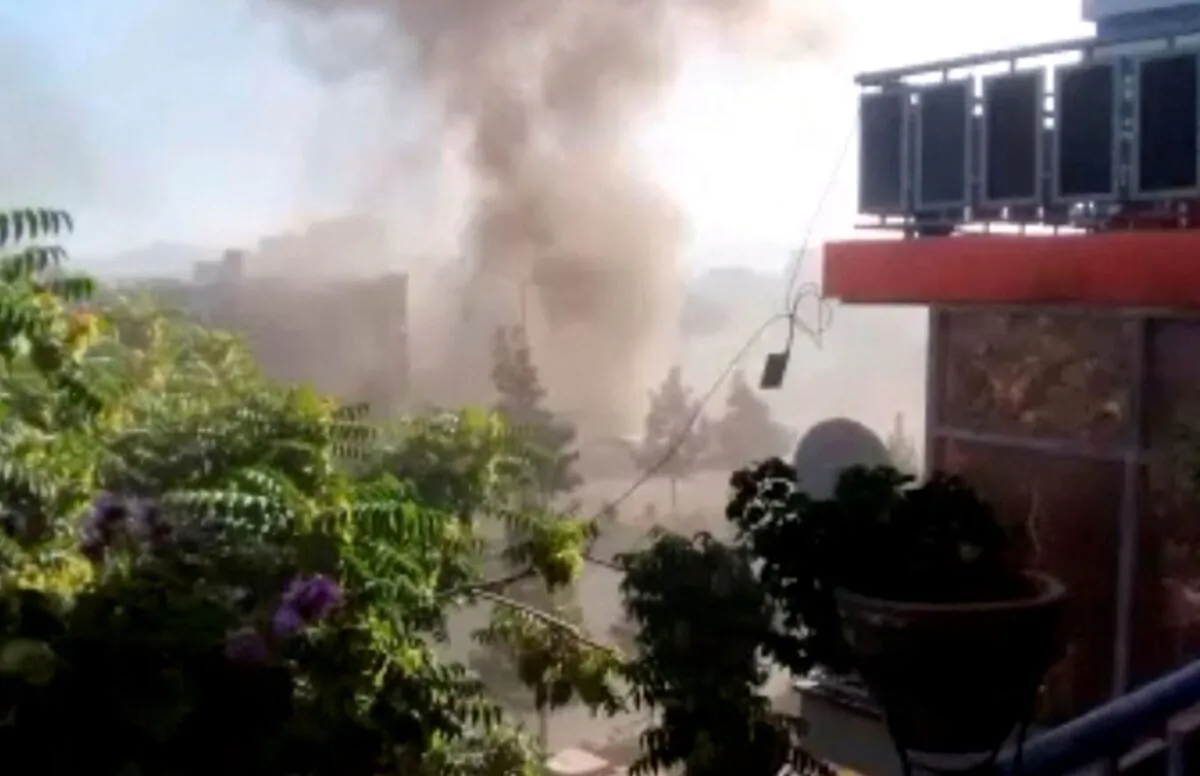 Smoke rises from a building near a Sikh temple following a blast in a car loaded with explosives in Kabul, Afghanistan, on June 18, 2022, in this still from video. (Social media video via Reuters)