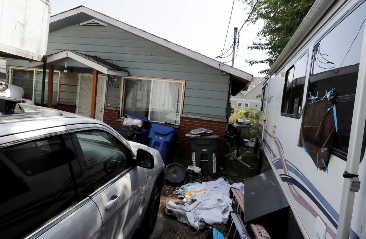 Vehicles are parked outside the home of Paige A. Thompson, who uses the online handle "Erratic," in Seattle. (Ted S. Warren/AP Photo)