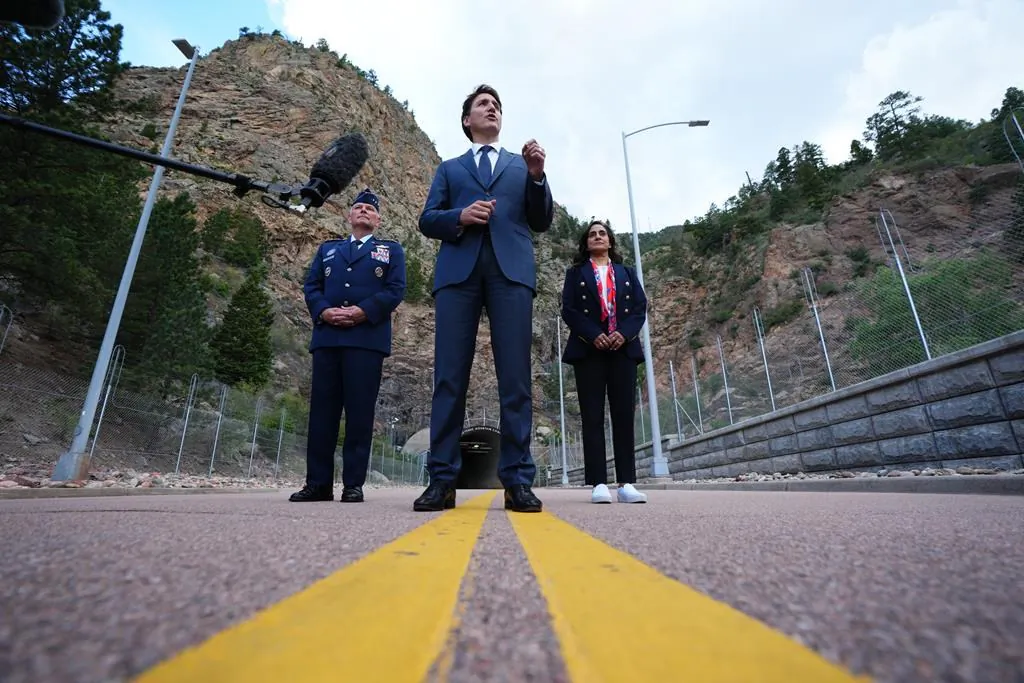 Prime Minister Justin Trudeau speaks to members of the media as Gen. Glen VanHerck, Commander of United States Northern Command and North American Aerospace Defense Command, and Canadian Minister of National Defence Anita Anand look on at the Cheyenne Mountain Space Force Station facility in Colorado Springs, Colo., on June 7, 2022. (The Canadian Press/Sean Kilpatrick)