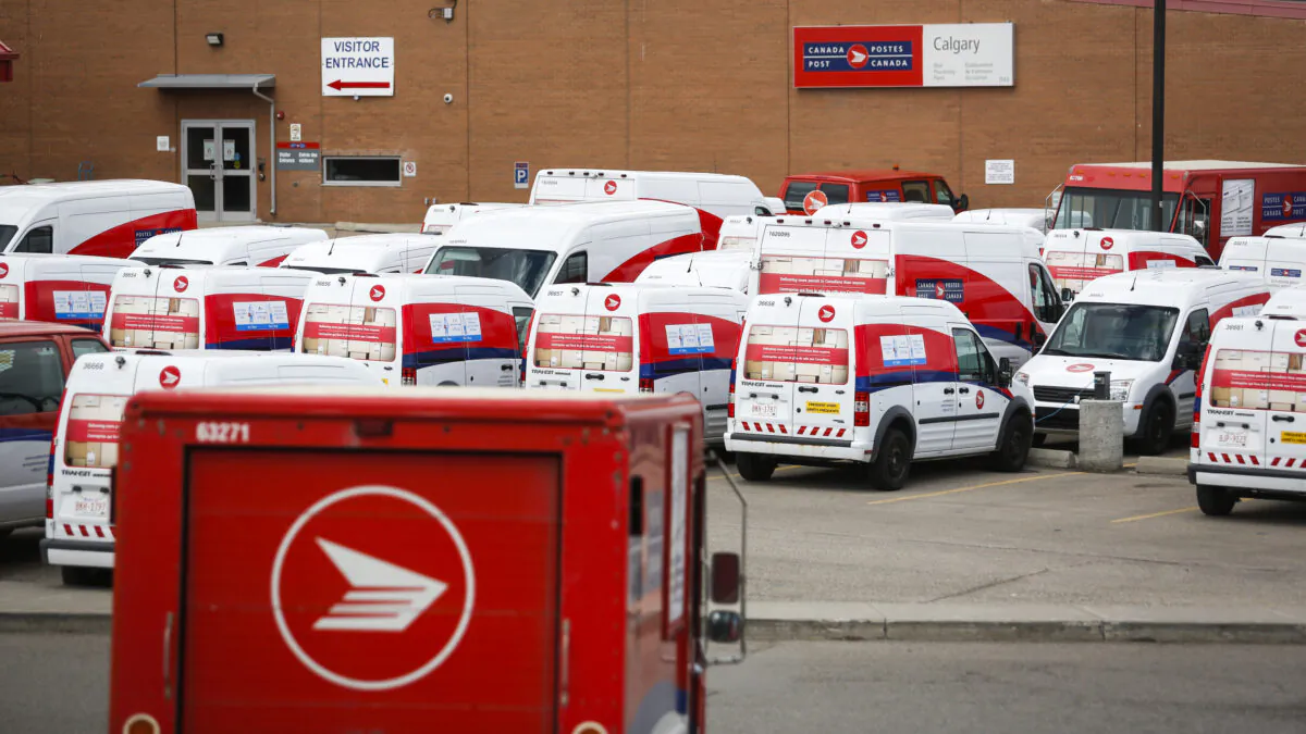 Delivery vehicles parked at Canada Post's main plant in Calgary, in a file photo. (The Canadian Press/Jeff McIntosh)