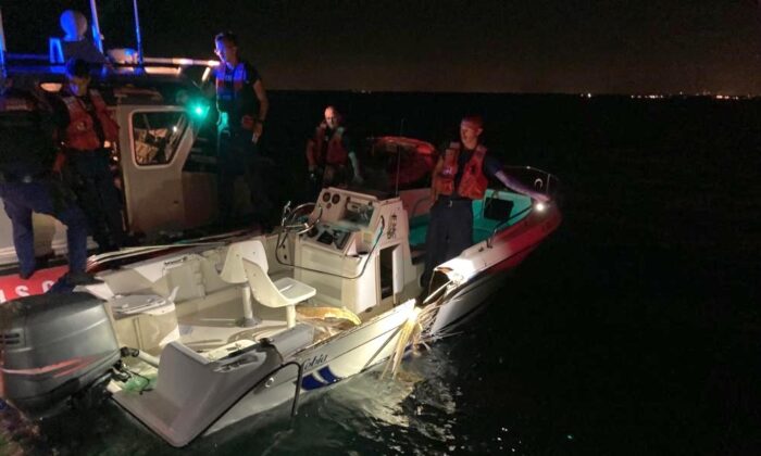 Coast Guard Station Miami Beach small boat crew inspecting a boat that was part of a collision near Key Biscayne, Florida, June 17, 2022. (U.S. Coast Guard photo by Station Miami Beach)