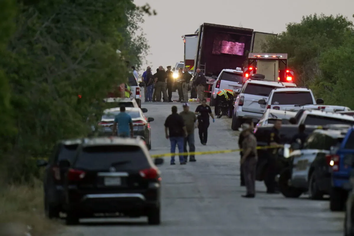 Police and other first responders work the scene where officials say dozens of people have been found dead and multiple others were taken to hospitals with heat-related illnesses after a semitrailer containing suspected illegal immigrants was found in San Antonio, Texas, on June 27, 2022. (Eric Gay/AP Photo)