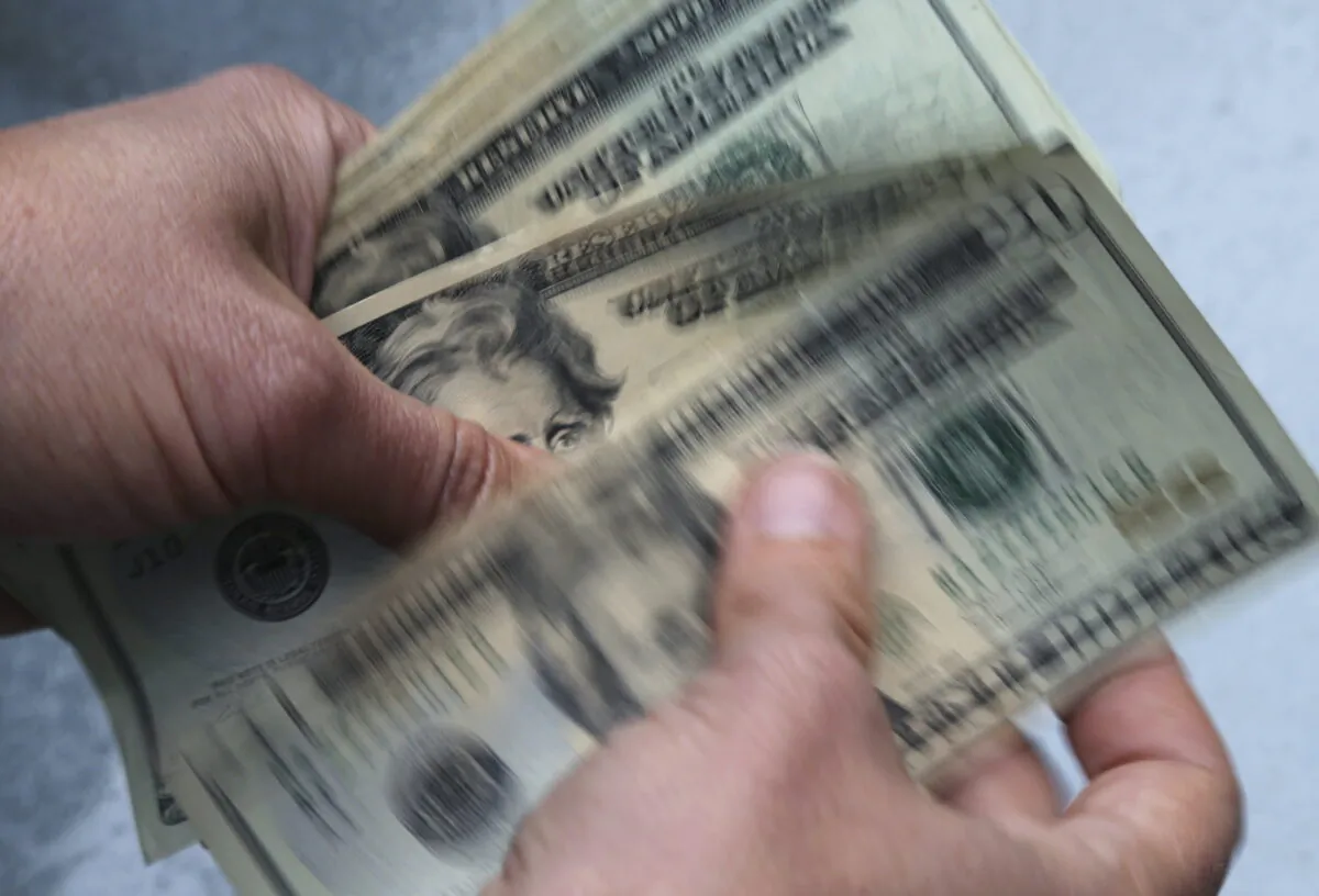 Twenty-dollar bills are counted in North Andover, Mass. on June 15, 2018. (Elise Amendola/AP Photo)